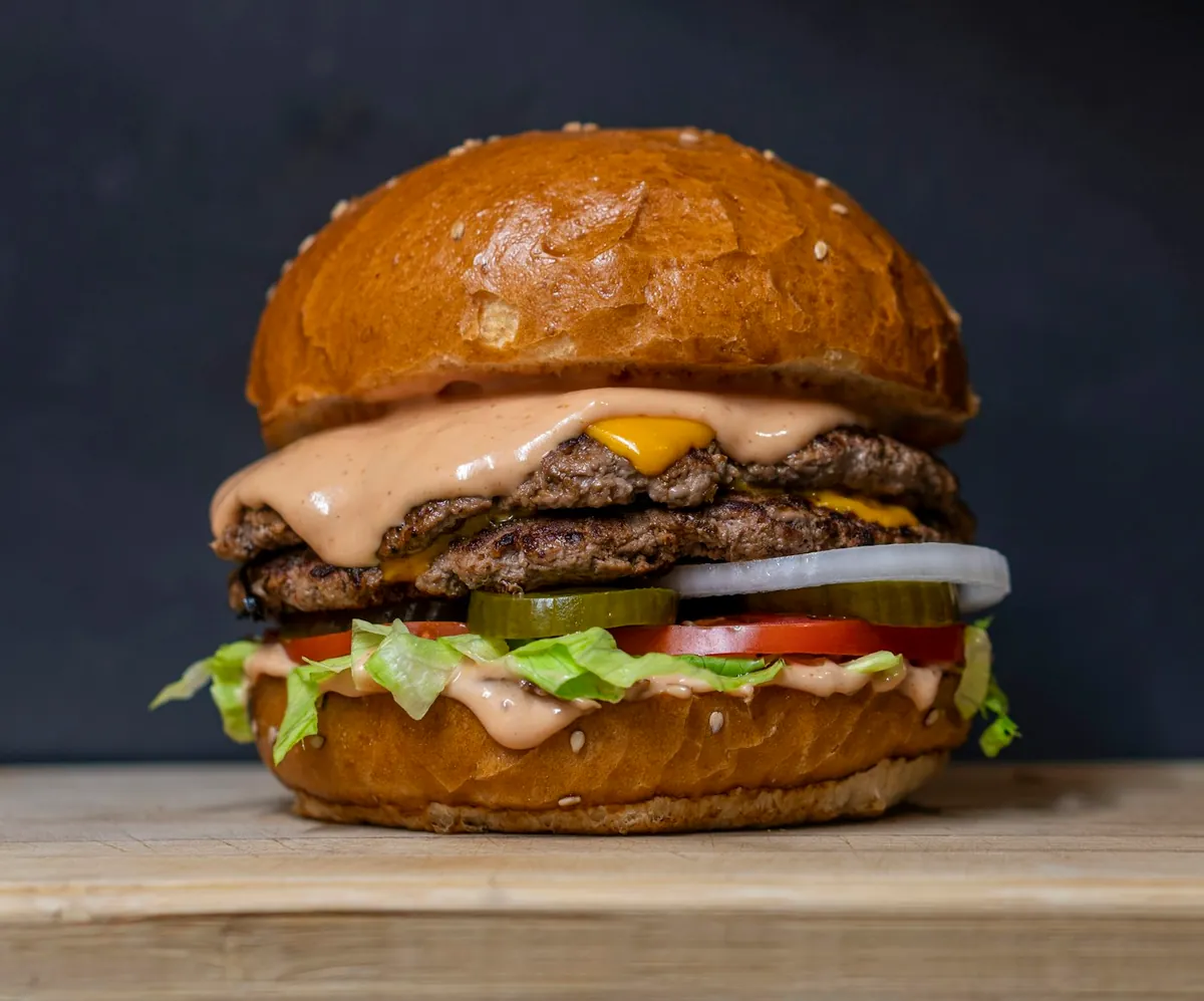 A burger stacked with fresh toppings